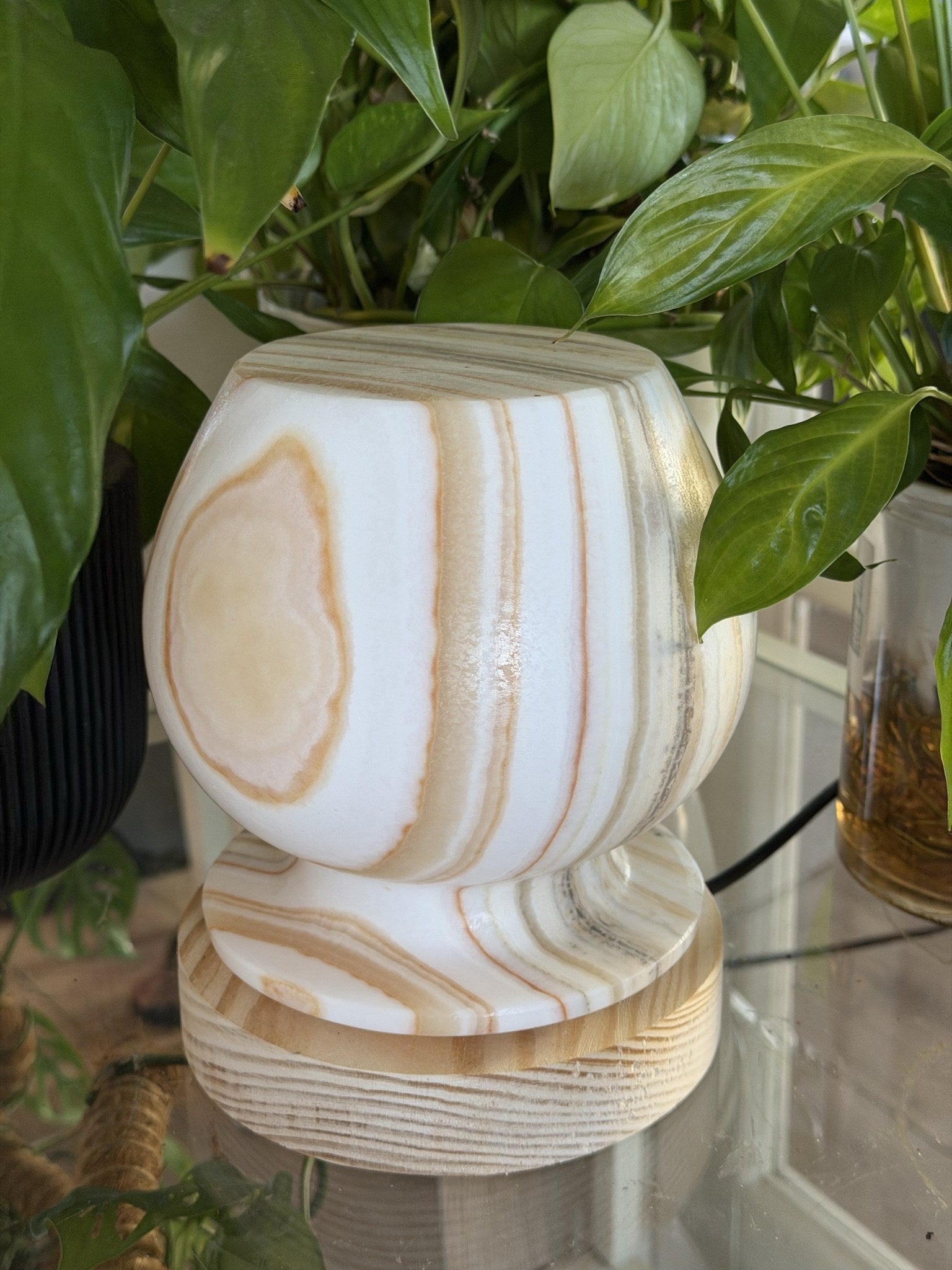 The Barrel lamp unlit from a closer angle, showing a pale tan almond-shaped marking within the banded stone