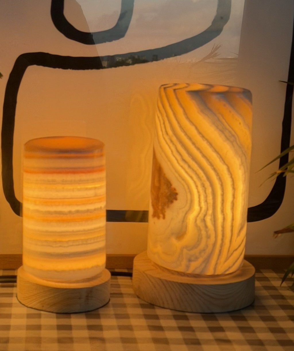 The Pillar Pair lit together, the Medium and Large alabaster columns side by side glowing warm amber