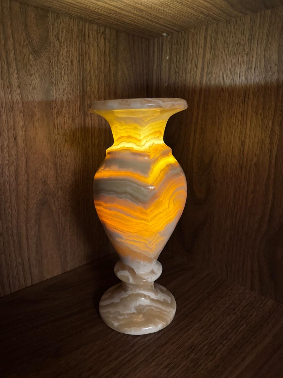 Decorative vase with a marbled pattern on a wooden surface