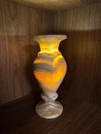 Decorative vase with a marbled pattern on a wooden surface