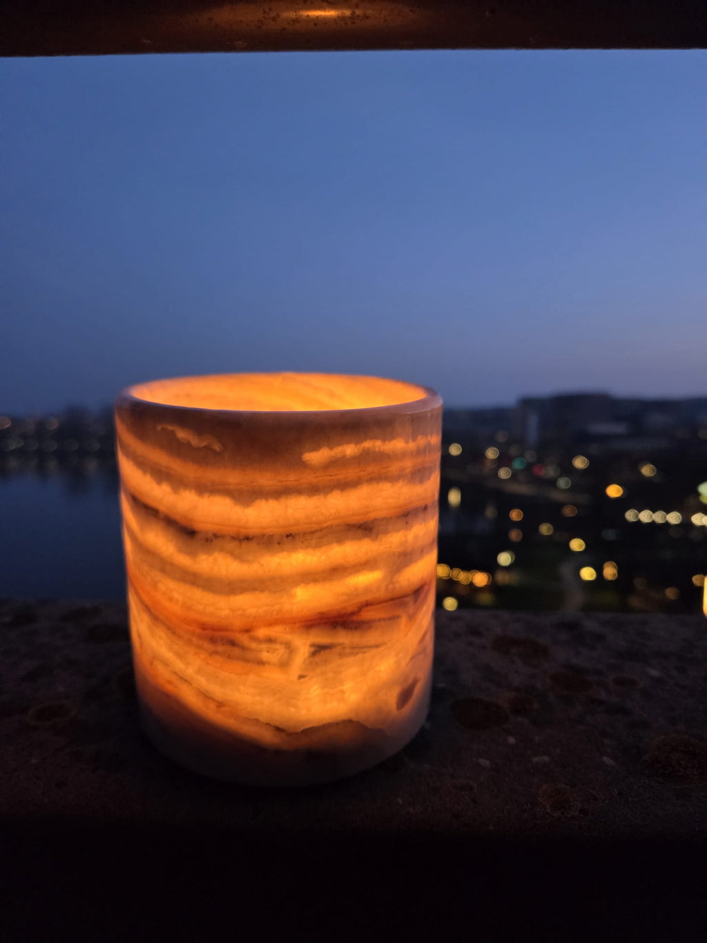 egyptian alabaster candle holder glowing balcony dusk