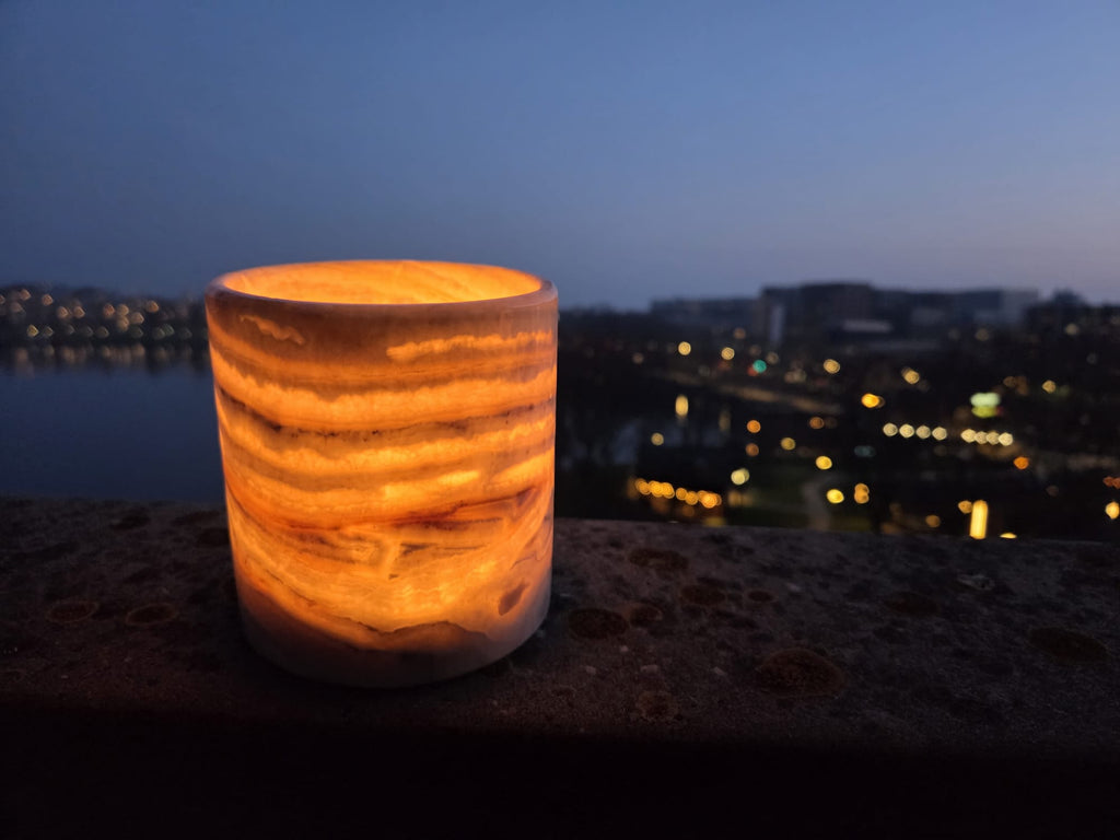 alabaster candle holder warm glow evening cityscape