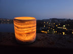 alabaster candle holder warm glow evening cityscape